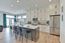 Sleek modern kitchen in bungalow perfect for retired couple and empty nesters. Luxury homes with RV garage.